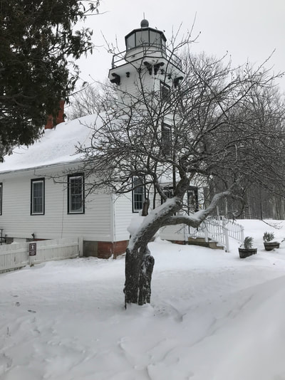 Mission Point Lighthouse in winter snow 