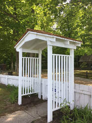 new white arbor built at fence similar to historic photos from 1910