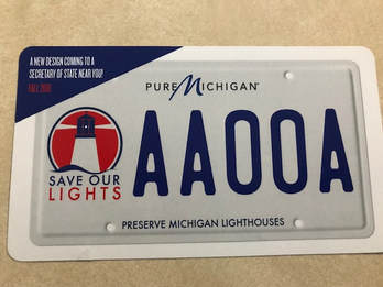 Save our Lighthouses license plate white with blue letters and red logo