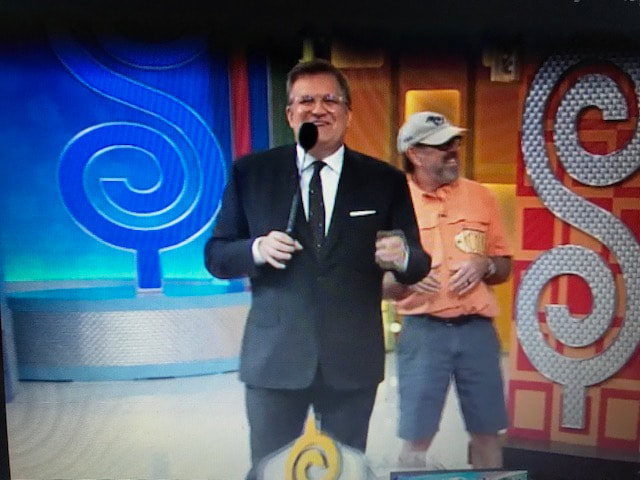 Contestant on The Price is Right wearing Mission Point Lighthouse hat