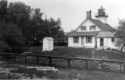 Historical black and white photo of rear of lighthouse